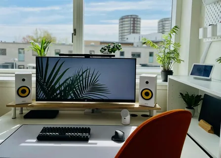 A modern illuminated gaming setup showcasing high-performance screens and lighting